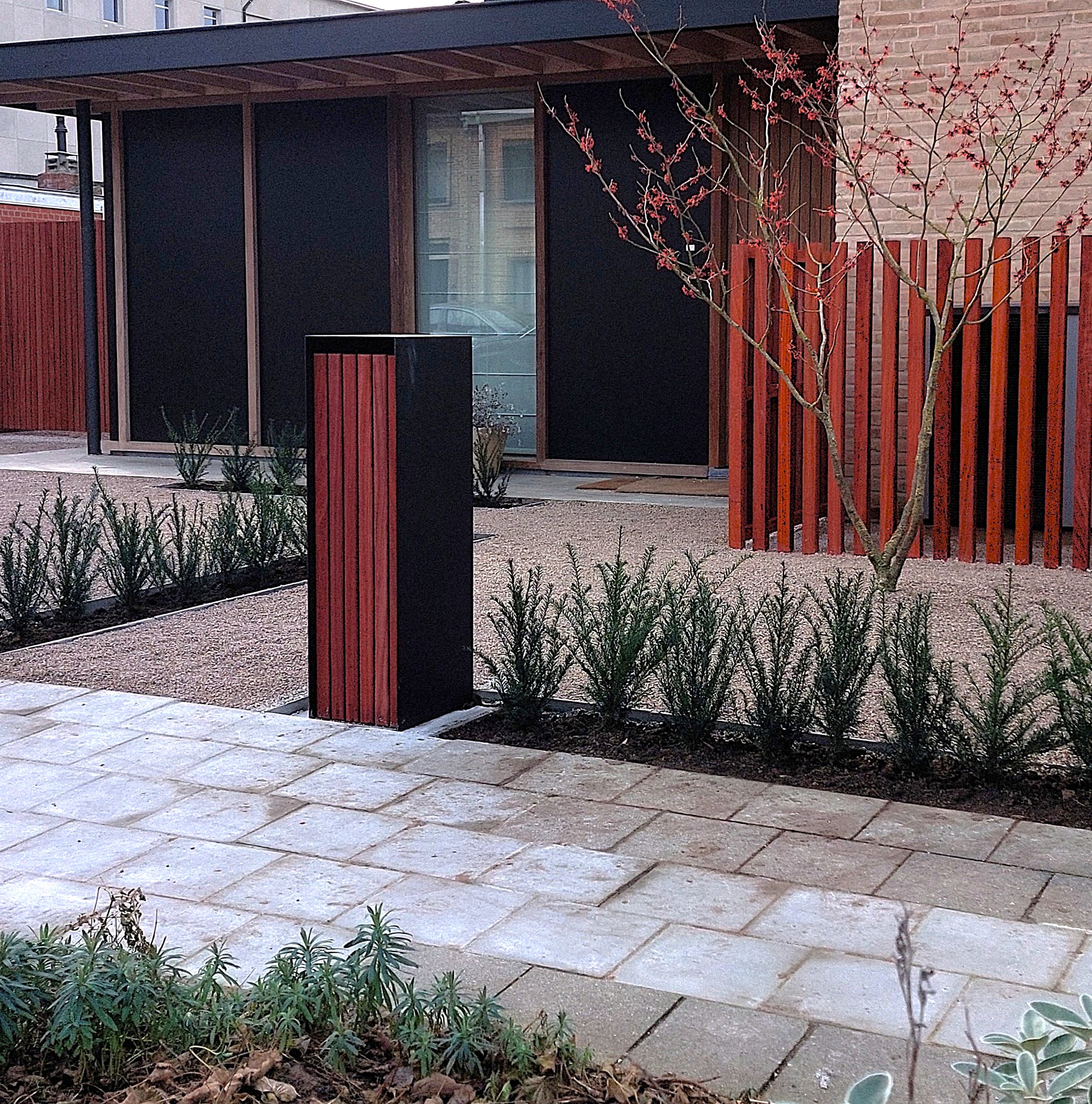 Mailbox with a padouk wood finish in a modern garden